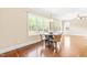 Dining area with hardwood floors, lots of natural light, and view to green landscaped lawn at 7945 Parker Mill Trail, Fuquay Varina, NC 27526