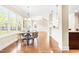 Well lit dining area with wood floors, large windows, and kitchen view at 7945 Parker Mill Trail, Fuquay Varina, NC 27526