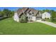 Inviting two-story home featuring a well-manicured lawn, stone accents, and an attached two-car garage at 7945 Parker Mill Trail, Fuquay Varina, NC 27526