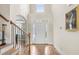 Grand foyer features hardwood floors, soaring ceilings, and a staircase with decorative iron spindles at 7945 Parker Mill Trail, Fuquay Varina, NC 27526