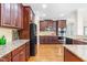 Spacious kitchen with dark wood cabinets, stainless steel appliances, granite counters and hardwood floors at 7945 Parker Mill Trail, Fuquay Varina, NC 27526