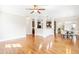 Bright, open-concept living space featuring hardwood floors and a view of the kitchen and dining areas at 7945 Parker Mill Trail, Fuquay Varina, NC 27526