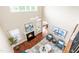 Bright living room boasts high ceilings, fireplace, hardwood floors, and an open concept design at 7945 Parker Mill Trail, Fuquay Varina, NC 27526