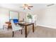 An office featuring a ceiling fan, carpet, neutral paint, and lots of natural light with an adjacent staircase at 7945 Parker Mill Trail, Fuquay Varina, NC 27526