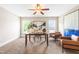 Bright office featuring neutral walls, carpet floors, modern art, ceiling fan, and two leather chairs at 7945 Parker Mill Trail, Fuquay Varina, NC 27526
