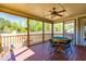 Screened porch with game table and ceiling fan at 7945 Parker Mill Trail, Fuquay Varina, NC 27526