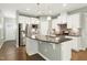 Spacious kitchen with an island, stainless steel appliances, and hardwood floors at 1009 Santiago St, Durham, NC 27703