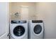 Laundry room with a front load washer and dryer, small shelves, and natural light at 1009 Santiago St, Durham, NC 27703