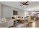 Open concept living room showcases neutral furnishings, stylish rug, ceiling fan, and easy access to the dining and kitchen areas at 1009 Santiago St, Durham, NC 27703