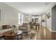 Bright living area offering open layout to dining and kitchen spaces with neutral furnishings, ceiling fan, and seamless transitions at 1009 Santiago St, Durham, NC 27703