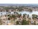Aerial view showing home's location on a lake with surrounding houses and trees at 101 Monterey Ln, Durham, NC 27713