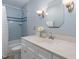 Updated bathroom with light blue walls, white vanity, and a shower/tub combo at 101 Monterey Ln, Durham, NC 27713