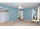 Bedroom with light blue walls, carpet, and access to a bathroom at 101 Monterey Ln, Durham, NC 27713