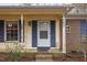 Inviting front porch with blue shutters and brick steps at 101 Monterey Ln, Durham, NC 27713