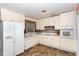 Bright kitchen with white cabinets and appliances at 101 Monterey Ln, Durham, NC 27713
