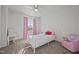 Light and airy bedroom with a pink accent chair at 105 Kcf Dr, Elon, NC 27244