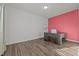 Home office with a desk and coral accent wall at 105 Kcf Dr, Elon, NC 27244