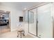 Bright bathroom featuring a glass shower, white tiling, and a luxurious soaking tub at 105 Scoville Rd, Garner, NC 27529