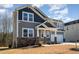 Charming two-story home with gray siding, stone accents, covered porch, and well-maintained landscaping at 105 Scoville Rd, Garner, NC 27529