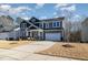 Gray siding, stone accents, two-story home with a two-car garage and landscaped lawn at 105 Scoville Rd, Garner, NC 27529