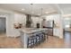 White kitchen cabinets, granite countertop, and island with seating at 105 Scoville Rd, Garner, NC 27529