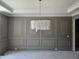 Elegant dining room with decorative wall paneling and modern chandelier at 109 Evander Way, Pittsboro, NC 27312