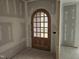 Arched wood door with glass inserts at future home's entry at 109 Evander Way, Pittsboro, NC 27312