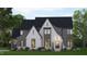 Two-story home with gray and white brick exterior, large windows and landscaped lawn at 109 Evander Way, Pittsboro, NC 27312