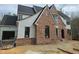 Home's exterior features brick accents, siding, and black framed windows at 109 Evander Way, Pittsboro, NC 27312