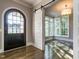 Foyer with dark wood door and hardwood floors leads into a bright room at 109 Evander Way, Pittsboro, NC 27312