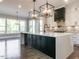 This stylish kitchen features a large island, custom backsplash, and modern lighting at 109 Evander Way, Pittsboro, NC 27312