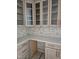 Elegant kitchen counter with glass cabinets, designer backsplash, and modern hardware at 109 Evander Way, Pittsboro, NC 27312