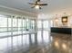 Open floor plan with hardwood floors connecting the living room, kitchen, and screened-in porch at 109 Evander Way, Pittsboro, NC 27312