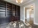 Office with dark wood built-in shelves and hardwood floors for a timeless look at 109 Evander Way, Pittsboro, NC 27312