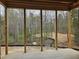 Screened in porch offers a serene view of the wooded lot and natural surroundings at 109 Evander Way, Pittsboro, NC 27312