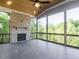 The screened-in porch features a stone fireplace and views of the wooded backyard at 109 Evander Way, Pittsboro, NC 27312