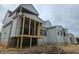 Home exterior featuring wood frame porch, neutral siding, and multiple window placements at 109 Evander Way, Pittsboro, NC 27312