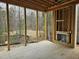 Screened porch with wooden frame shows fireplace and wooded backdrop at 109 Evander Way, Pittsboro, NC 27312