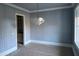 Dining Room featuring wainscoting and a modern chandelier at 129 Windel Dr, Raleigh, NC 27609