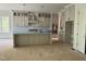 A spacious kitchen features a large island, modern appliances, custom cabinets, and unfinished flooring at 129 Windel Dr, Raleigh, NC 27609