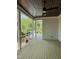Covered patio with wood ceiling, ceiling fan and views of the landscaped backyard at 129 Windel Dr, Raleigh, NC 27609