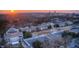 Aerial view of college campus showing academic buildings with city skyline in background at sunset at 1300 Broad St # A, Durham, NC 27705