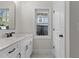 Modern bathroom with white vanity and a window at 1300 Broad St # A, Durham, NC 27705