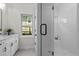 Bright bathroom with glass shower, a window, and marble countertops at 1300 Broad St # A, Durham, NC 27705