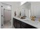 Elegant bathroom with double vanity, quartz countertops, dark cabinets, and large framed mirror at 1300 Broad St # A, Durham, NC 27705