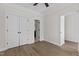 Spacious bedroom with hardwood floors, a double closet, and a doorway to an adjoining room at 1300 Broad St # A, Durham, NC 27705