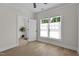 Bright bedroom featuring wood floors, a ceiling fan, and a large window with natural light at 1300 Broad St # A, Durham, NC 27705