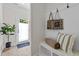 Cozy entryway with built-in bench seating, storage shelves, and decorative tote bags on coat hooks at 1300 Broad St # A, Durham, NC 27705