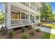Charming two-story condo with double porches, white railings, and landscaped front yard, creating a welcoming facade at 1300 Broad St # A, Durham, NC 27705