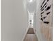 Long hallway with wood floors, crown molding and a decorative wall hanging at 1300 Broad St # A, Durham, NC 27705